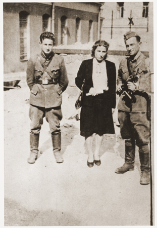 Three former Jewish partisans pose in the Vilna ghetto soon after the liberation